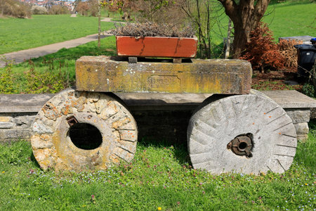 Flowerpot stands on two old stone wheels