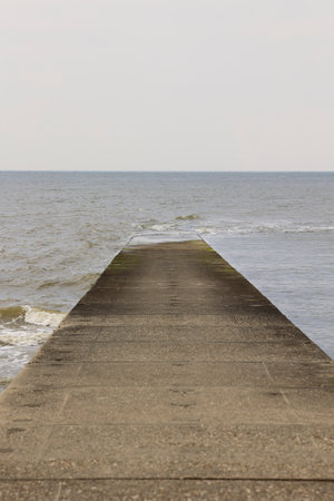 Breakwater on the beach of the island of Borkum protrudes into the North Seaの写真素材