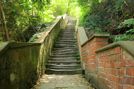 Staircase with crooked steps leads upwards into brightness