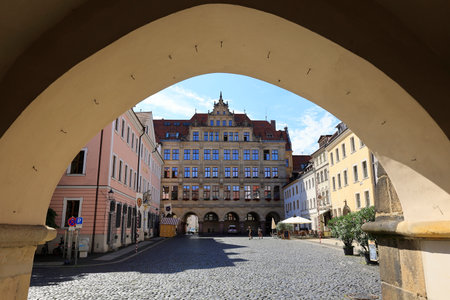Old town hall in the city of GÃ¶rlitz in Saxony photographed through an arch