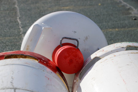Gas bottle with protective cap has fallen onto a gas bottleの写真素材