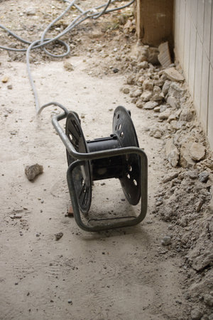 Cable drum lies in the dirt on a construction siteの写真素材