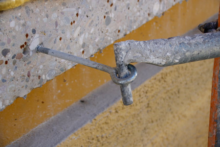Scaffolding is secured against falling over with a hook