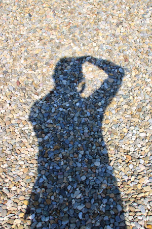 Silhouette of a photographer on gravelの写真素材
