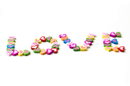 Word LOVE from the multicolored wood element in the shape of heartの写真素材