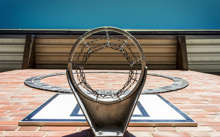 Public school outdoor, red wall and basket - Bottom viewの写真素材