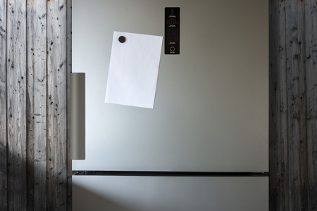 Empty Paper Sheet On Fridge Door - Infront Of Wooden Wallの写真素材