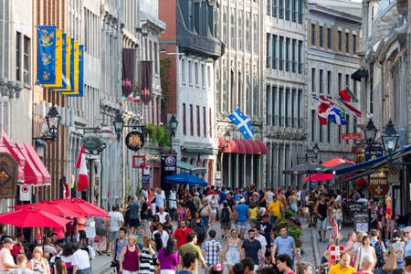 Old Montreal, July 1, 2015. Tourists and visitors walking and discovering the historical quarter on Canada day.のeditorial素材