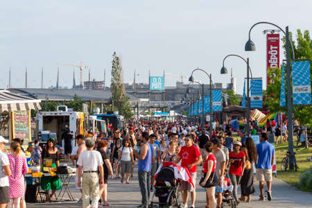 Montreal, July 1, 2015. Crowd of tourists enjoying the various activities at the historical Old Port in Old Montreal on Canada day.のeditorial素材