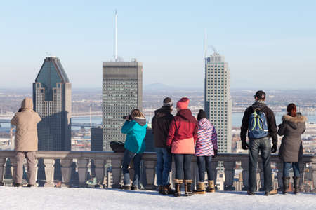 Montreal, March 8, 2015. Toruists and locals admiring the scenic view of the city skyline from the famed Mount-Royal on a sunny winter afternoon. Canada.のeditorial素材