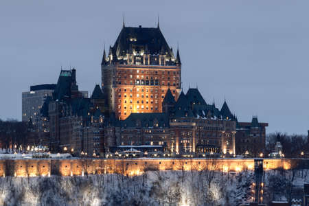Quebec city, January 21, 2017. Skyline view of the historical city and landmark buildings standing along the frozen Ste-Lawrence river at dawn on a foggy winter day. Canada.のeditorial素材
