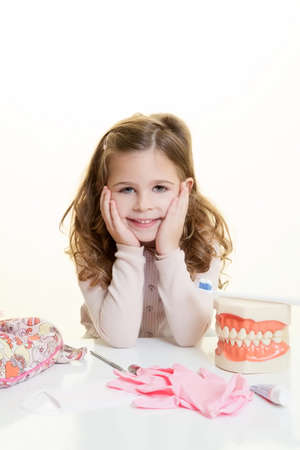 Happy smiling girl with dentist toolの写真素材