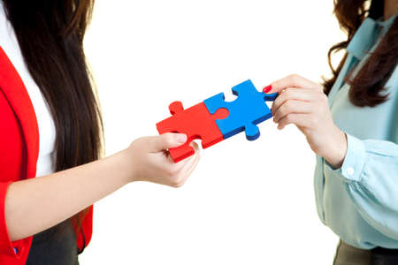 beautiful women  assembling jigsaw puzzleの写真素材