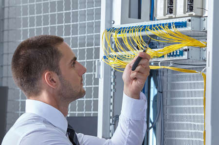 business man engeneer in modern datacenter server roomの写真素材