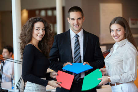 Group of business people assembling jigsaw puzzle and represent team supportの写真素材