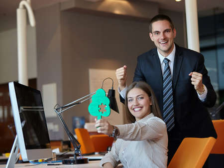 Group of business people assembling jigsaw puzzle and represent team supportの写真素材