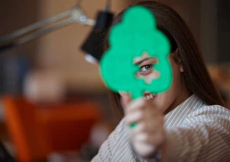business woman with tree puzzle looking happy and smilingの写真素材