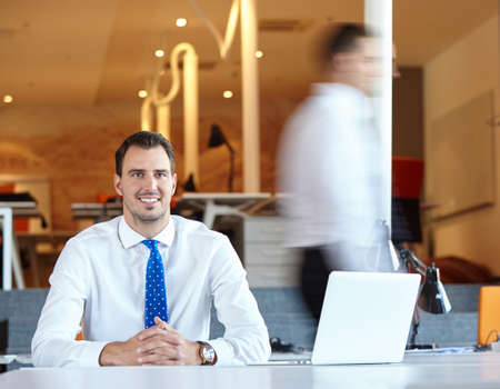 Elegant businessman analyzing data in officeの写真素材