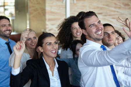 business partners discussing documents and ideas at meeting in officeの写真素材