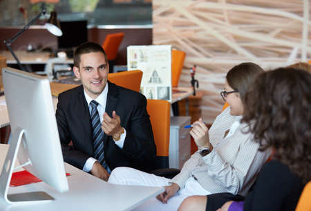 business partners discussing documents and ideas at meeting in office