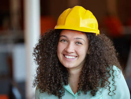Woman Architect at work site with blueprintsの写真素材
