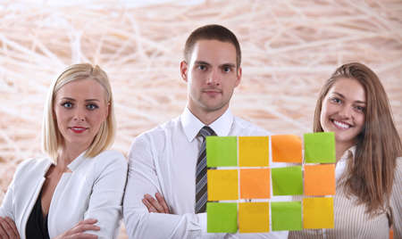 Businesswoman pointing on whiteboard in meeting with office