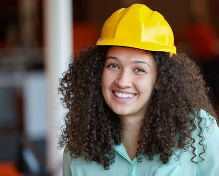 Woman Architect at work site with blueprintsの写真素材
