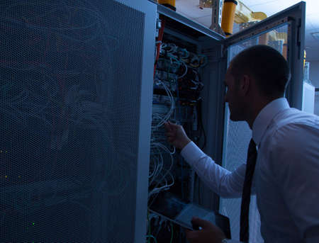 businessman hand using tablet computer and server roomの写真素材