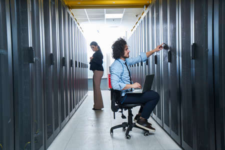 two young technicians working at a data center on server maintenanceの写真素材