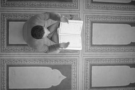 Religious muslim man praying inside the mosque