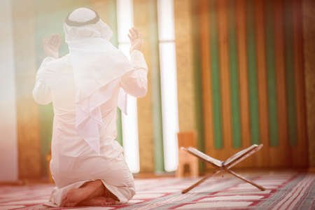 Religious muslim man praying inside the mosque