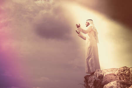 The iIslamic man praying   on the mountain.の写真素材