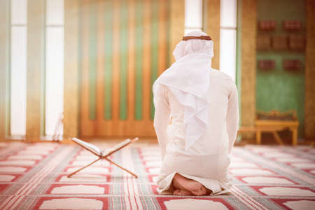 Religious muslim man praying inside the mosque