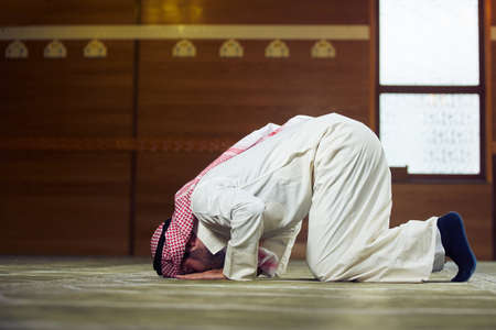 Religious muslim man praying inside the mosque