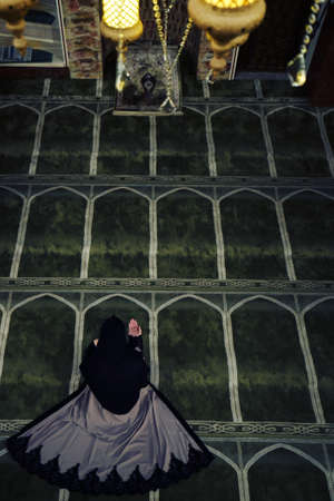 Young muslim woman praying in mosqueの写真素材