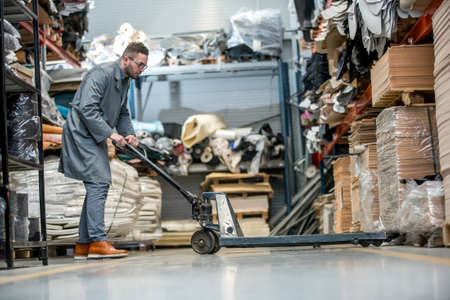 Working at leather warehouse at shoe factory used warehouse equipment. managerの写真素材