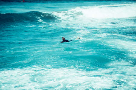 Surfing the waves of Indonesia beach. vacation concept