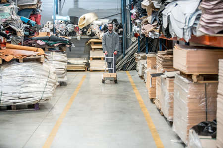 Working at leather warehouse at shoe factory used warehouse equipment. managerの写真素材