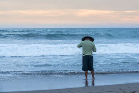 Man fishing in the evening at beachの写真素材