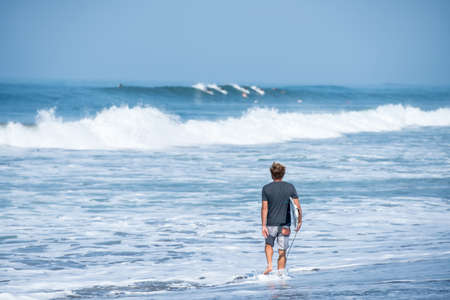 Surfing the waves of Indonesia beach. vacation conceptの写真素材