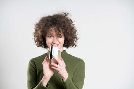 Hipster girl using blank credit card for online shopping. concept, on grey backgroundの写真素材