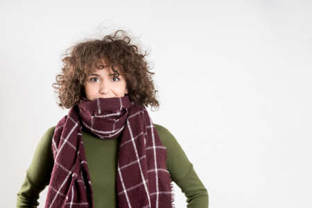 Hispter girl posing in a studio. gray background