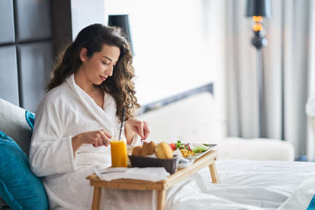 Breakfast in bed, cozy hotel room. conceptの写真素材