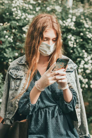 Stylish fashionable beautiful girl woman quarantined in spring with flowers and accessoriesの写真素材