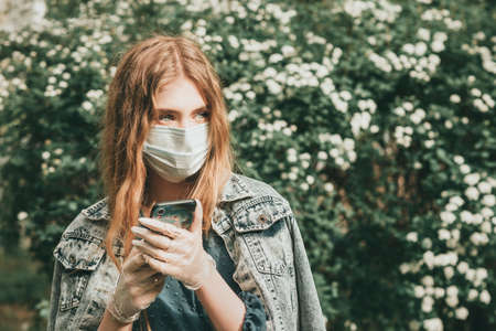 Stylish fashionable beautiful girl woman quarantined in spring with flowers and accessoriesの写真素材