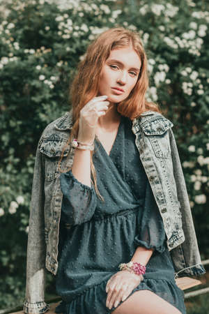 Stylish fashionable beautiful girl woman quarantined in spring with flowers and accessories