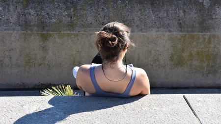 A teenager girl rests sitting on a tier after doing sportの写真素材