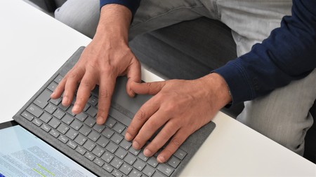 Male hands typing on a laptop