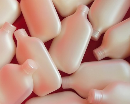 Cosmetic plastic containers on red backgroundの写真素材