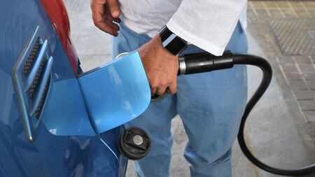 A driver fuels up the tank of his car